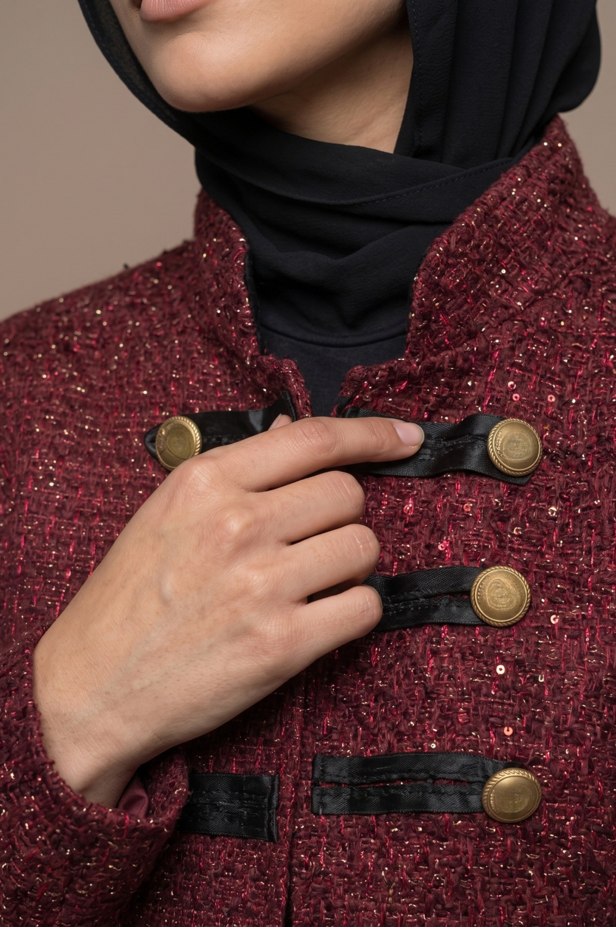Grenat burgundy texture, black trim and gold-tone buttons detail